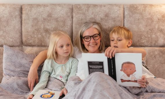 A grandmother reads bedtime stories to her two grandchildren, creating a warm family bond.